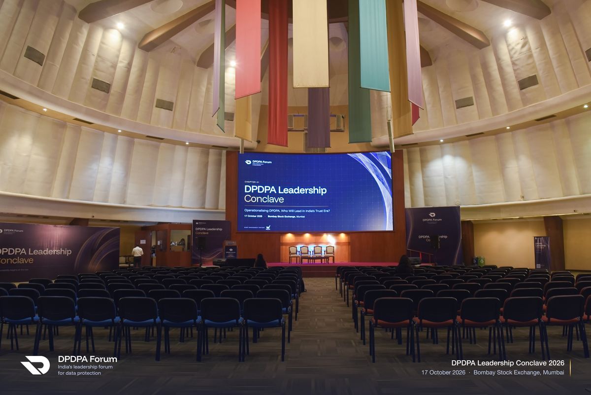 The hall at the Bombay Stock Exchange before Chapter 01 of the DPDPA Leadership Conclave, the Conclave screen lit above empty rows